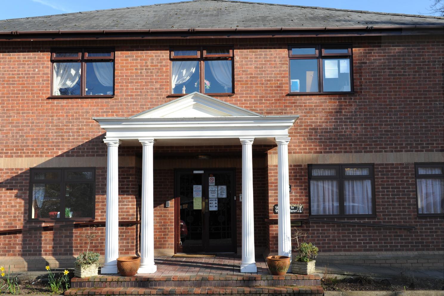exterior of the home with ceramic plant pots outside